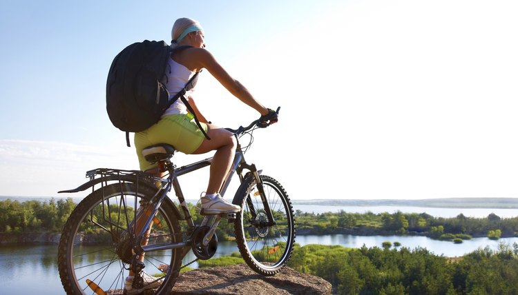 Girl with  bicycle on  mountain