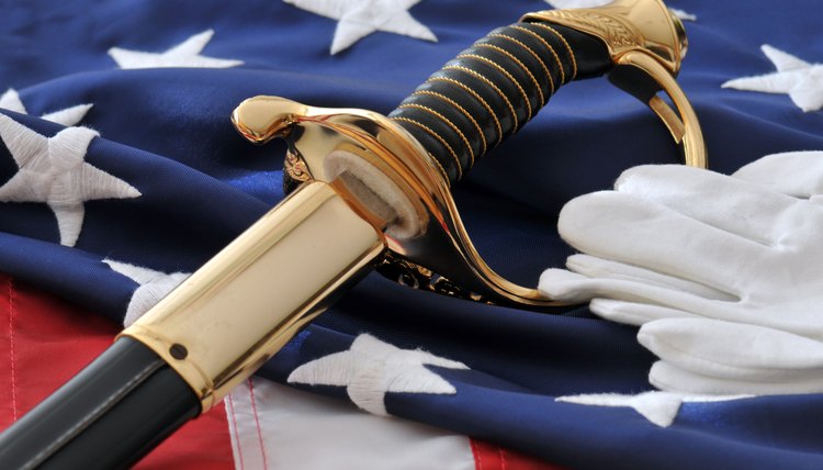 U.S. Marine Corp sabre, uniform white gloves and American flag background