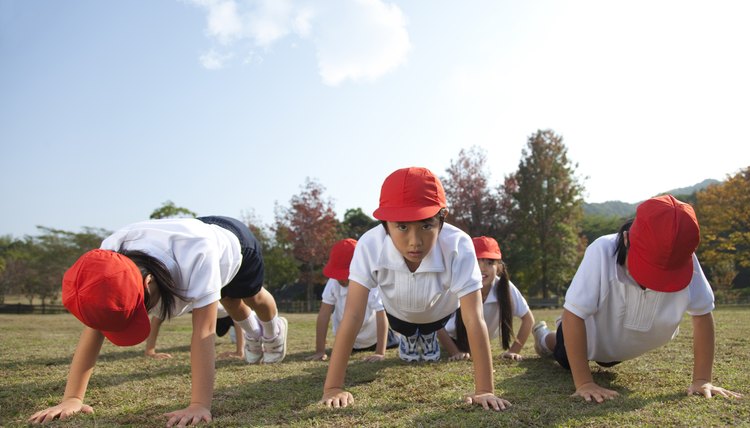 Elementary school children doing push ups, Japan