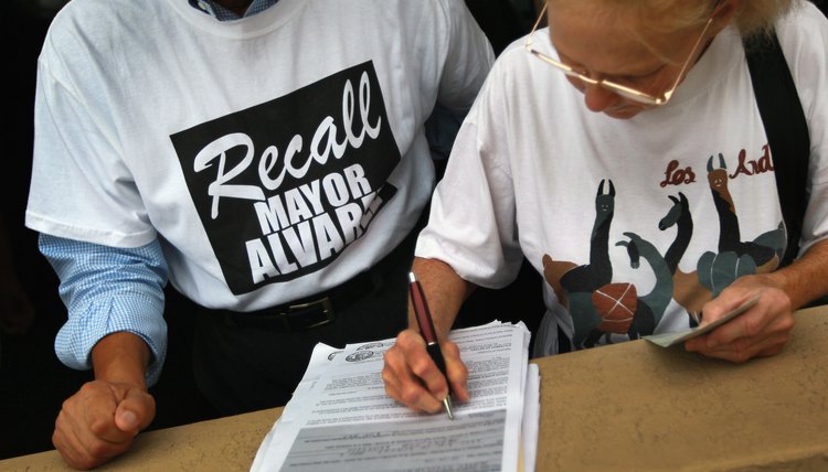 Marie Bond signs a petition to recall Miami-Dade County Mayor Carlos Alvarez