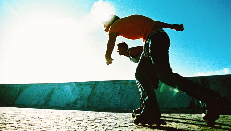 side profile of two young men roller skating