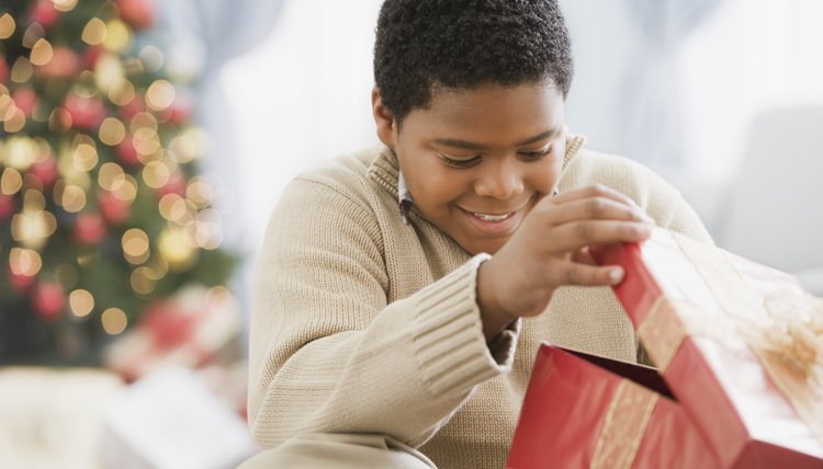 Young boy opening a Christmas present.