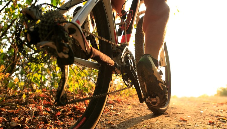 Detail of cyclist man feet riding mountain bike on outdoor