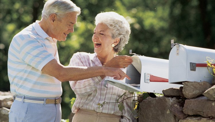 A couple is checking their mail.