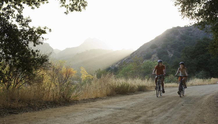 Active couple biking on scenic road.