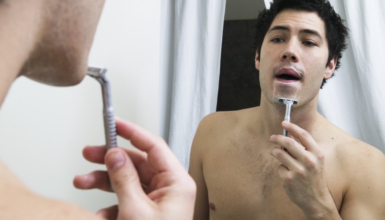 Man trimming his beard.
