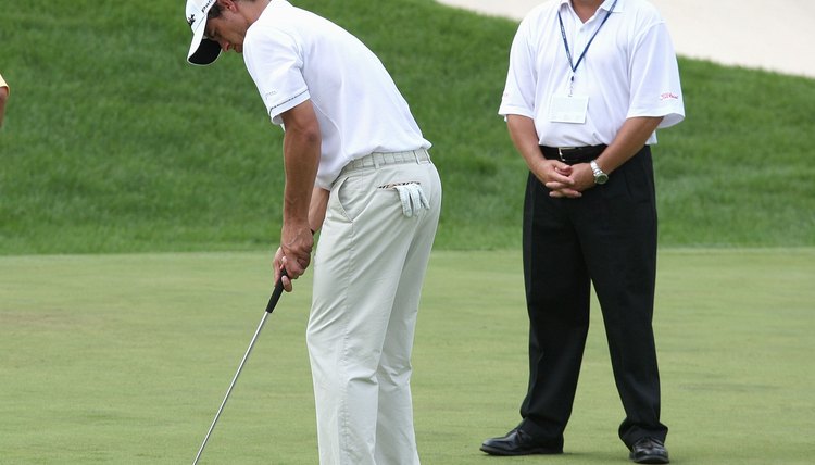 Scotty Cameron watches one of his putters in action as Adam Scott practices prior to the 2008 PGA Championship at Michigan's Oakland Hills Country Club.