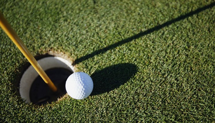 Golf ball close to pin
