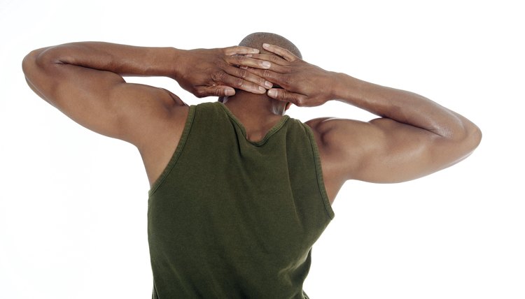 Man stretching with hands behind head