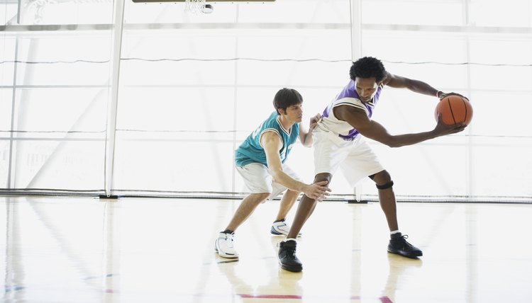 Opposing basketball players on court