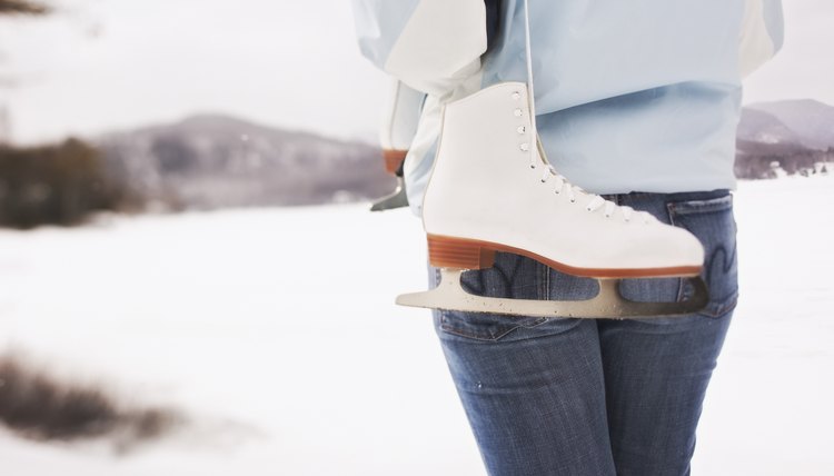 Back view of woman holding ice skates