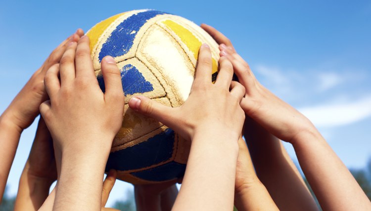 Group of young people playing volleyball