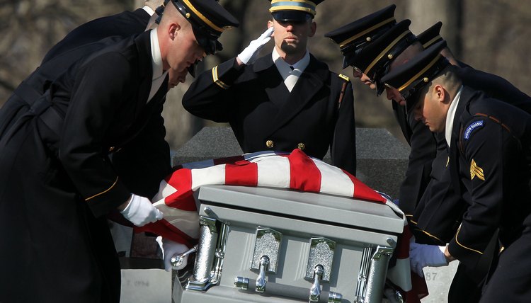 The flag code does require that the flag never touch the ground, so the flag should drape a casket only when it is being viewed.