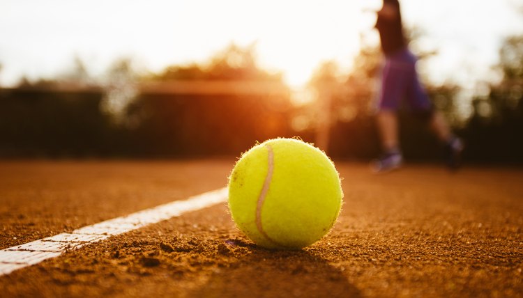 Silhouette of player on a tennis court