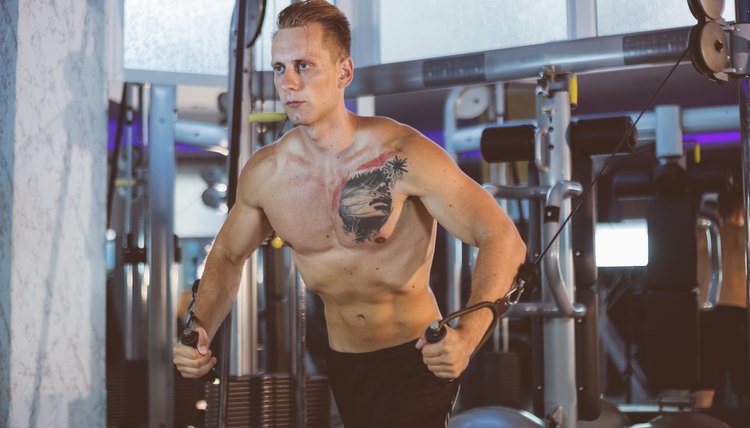 Young Handsome Bodybuilder Is Working On His Chest With Cable Crossover In A Well Equipped Gym