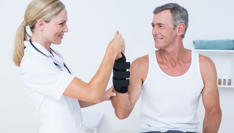 Doctor examining a man wrist