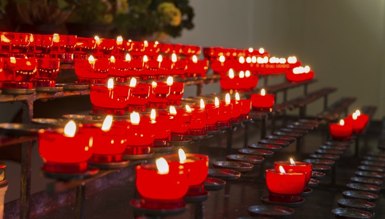 Close-up of red candle set-up in church.