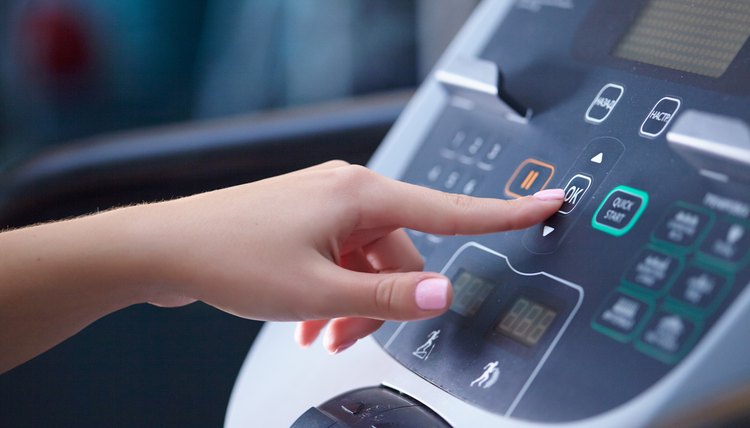 girl on a treadmill presses the button