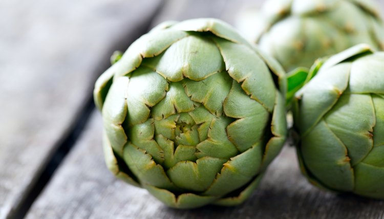 artichokes on wooden surface