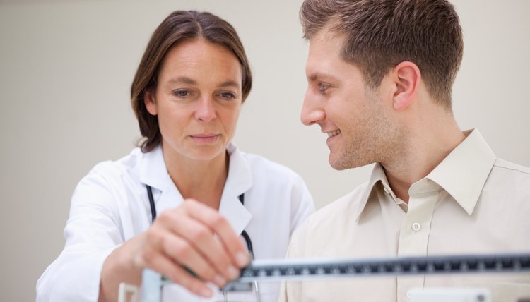 Doctor adjusting scale for her patient