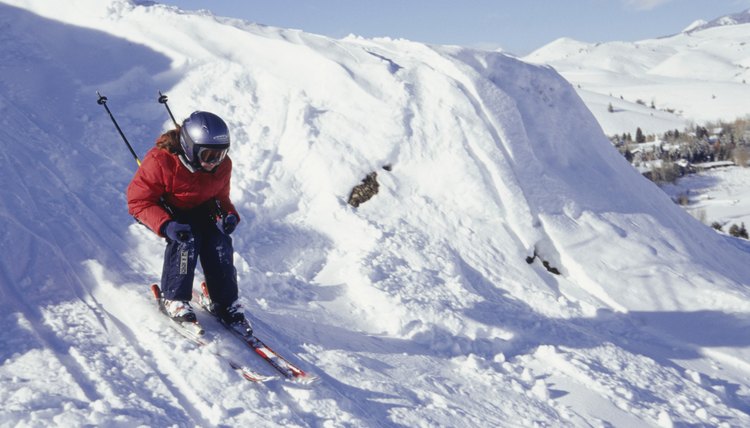 Girl (12-13) skiing down ski slope in mountains