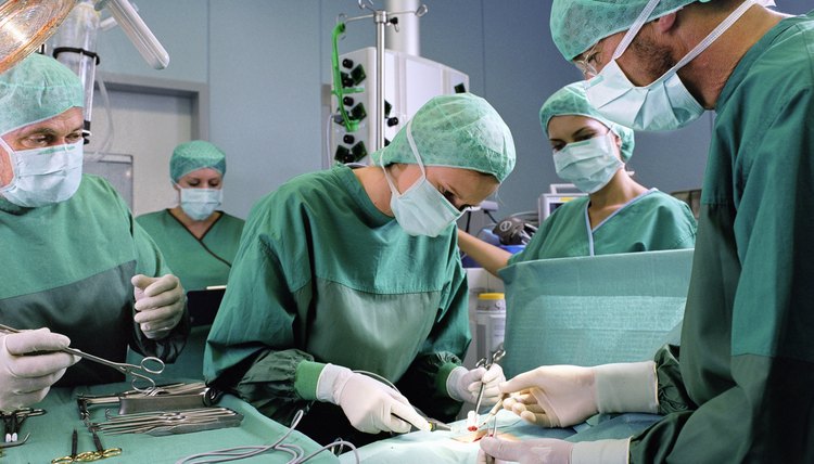 Group of surgeons working in operating theatre