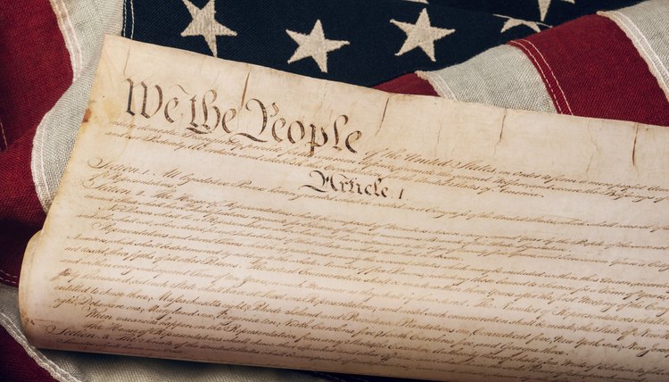 A replica of the U.S. Constitution atop an American flag