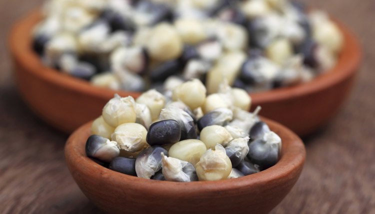 Small ceramic bowls filled with fresh corn kernals.