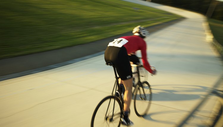 Cyclist on velodrome track, rear view
