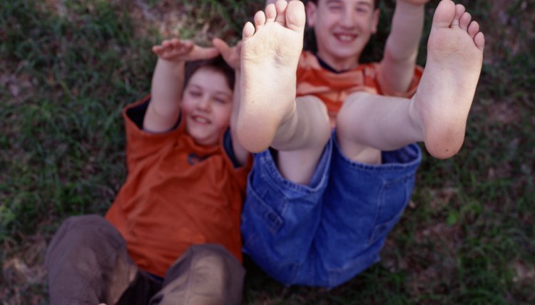 Boys lying down with feet and arms in the air
