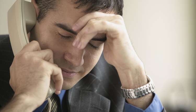 Man listening on a telephone.