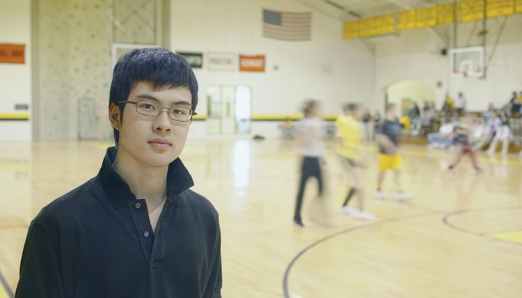 Teenage boy standing on basketball court