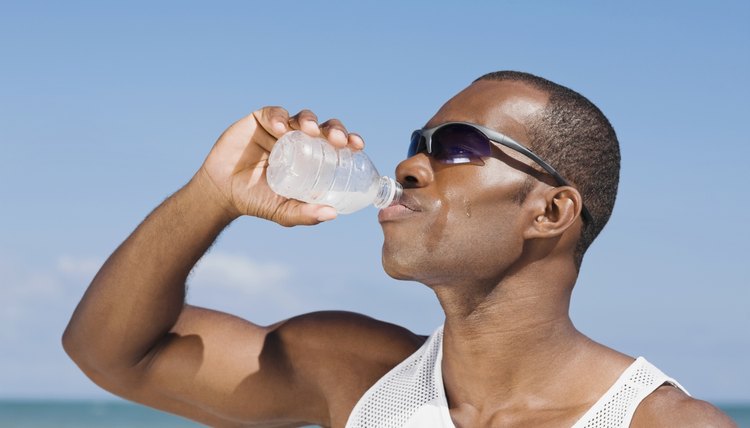 African man drinking water bottle