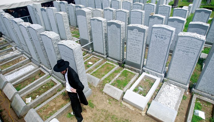 A mourner pays his respects at a Jewish cemetery.