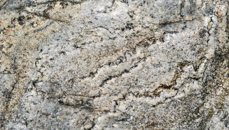 Weathering causes bits of rock to wear away, sometimes leaving holes or cracks.