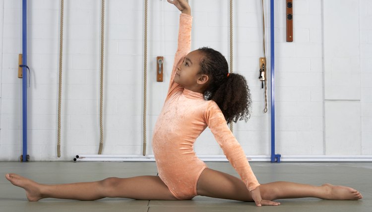 Young girl gymnast practicing her floor exercises