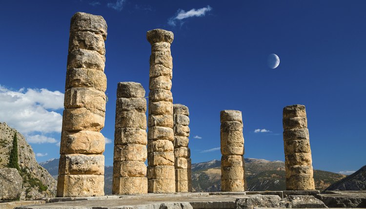 A crescent moon in the sky above an ancient Greek temple.