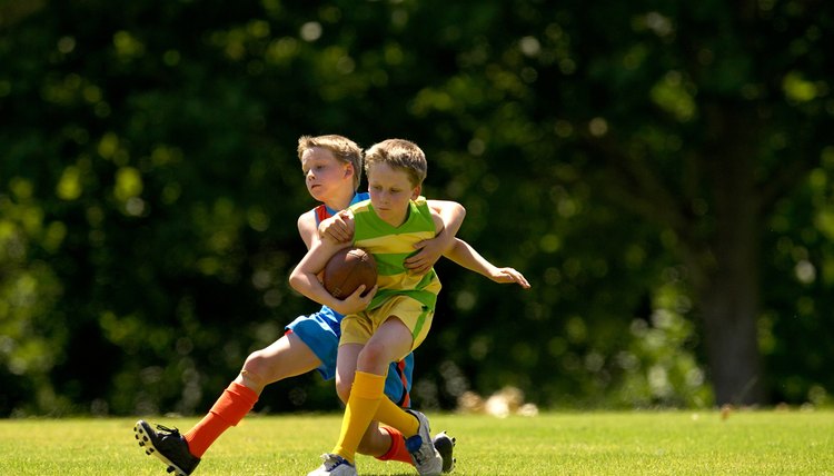 Young football player tackles opposition