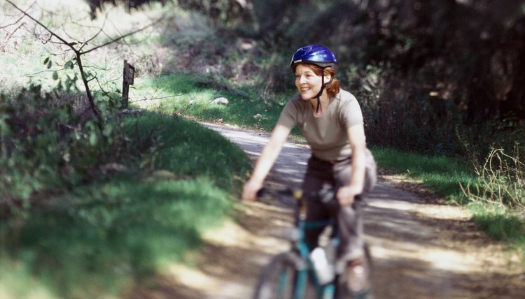 Woman riding mountain bike on a trail