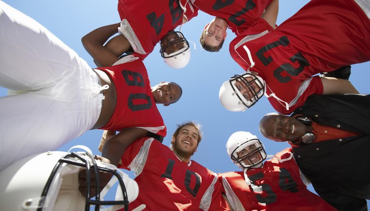 Football Players and Coach in Huddle