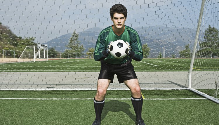 Soccer goalie holding ball