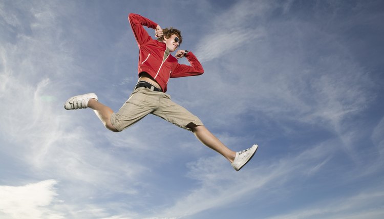 Teenage boy leaping in midair