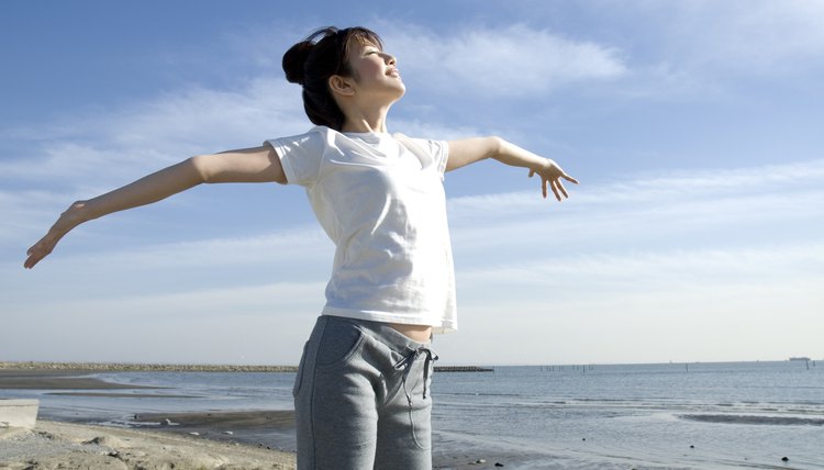 Young Woman Stretching Out Her Arms, Low Angle View, Side View 