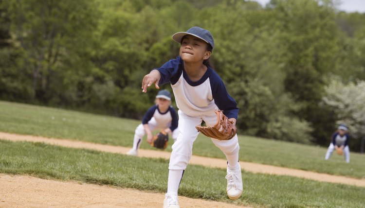 Girl throwing in little league softball game