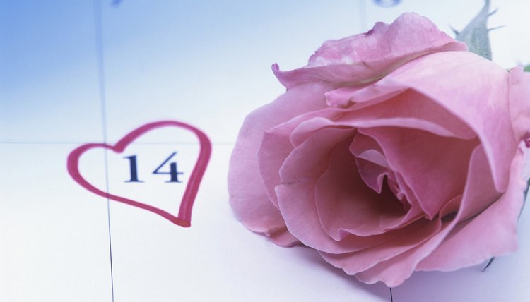 A rose on a calendar with a heart marking Valentine's Day.
