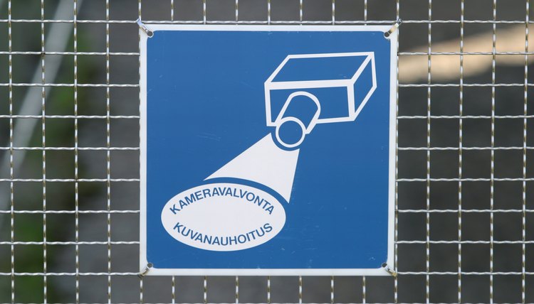 Surveillance sign on fence
