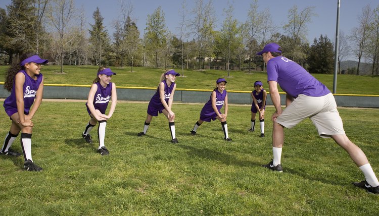 Coach and little league players stretching