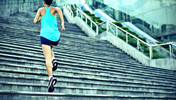 young sports woman running up on stone stairs