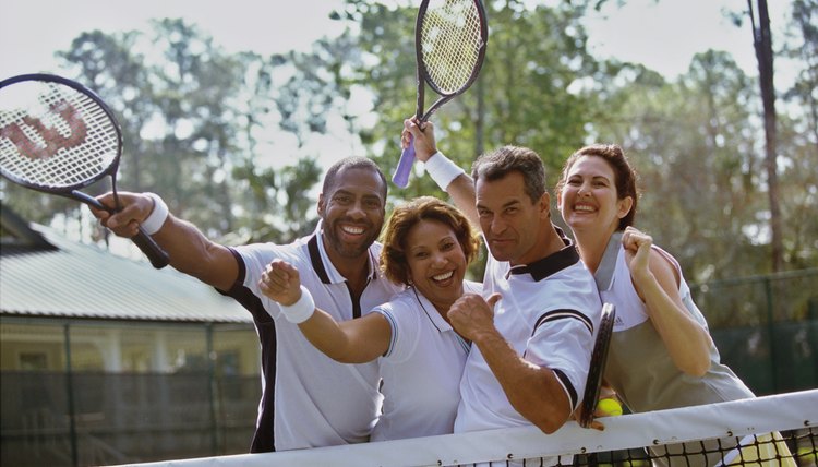 Portrait of two mid adult couples cheering