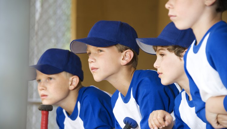 Young baseball players sitting in dugout